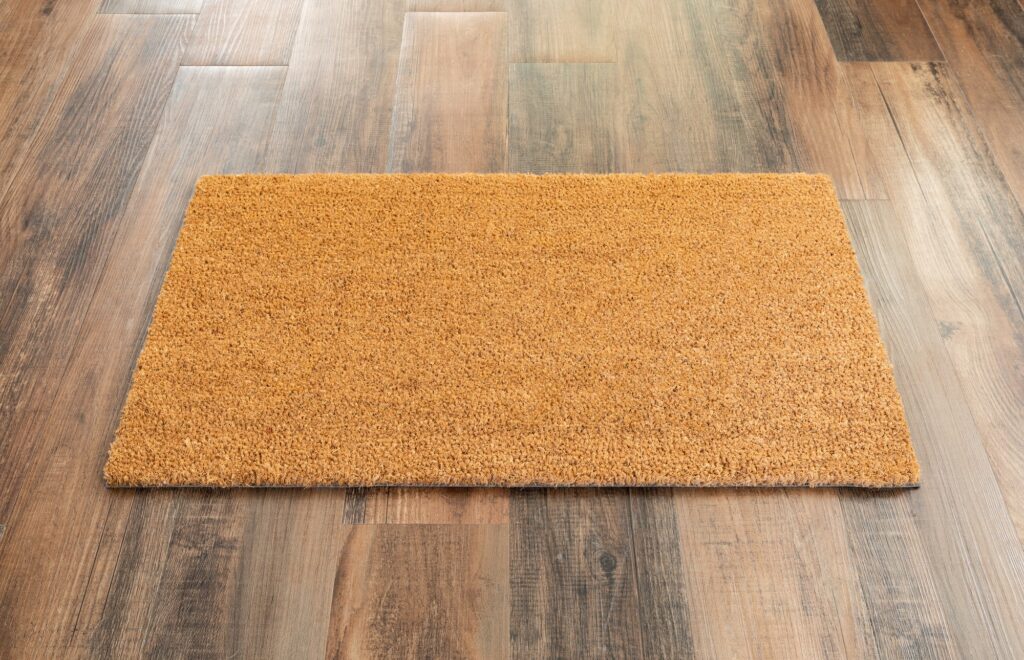 Blank Doormat On Wood Floor Background Ready For Your Own Text